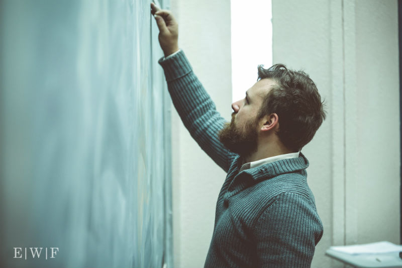 Luke does math at a chalkboard